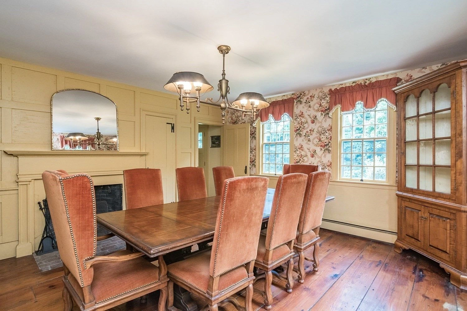 Formal dining room with fireplace and wood flooring